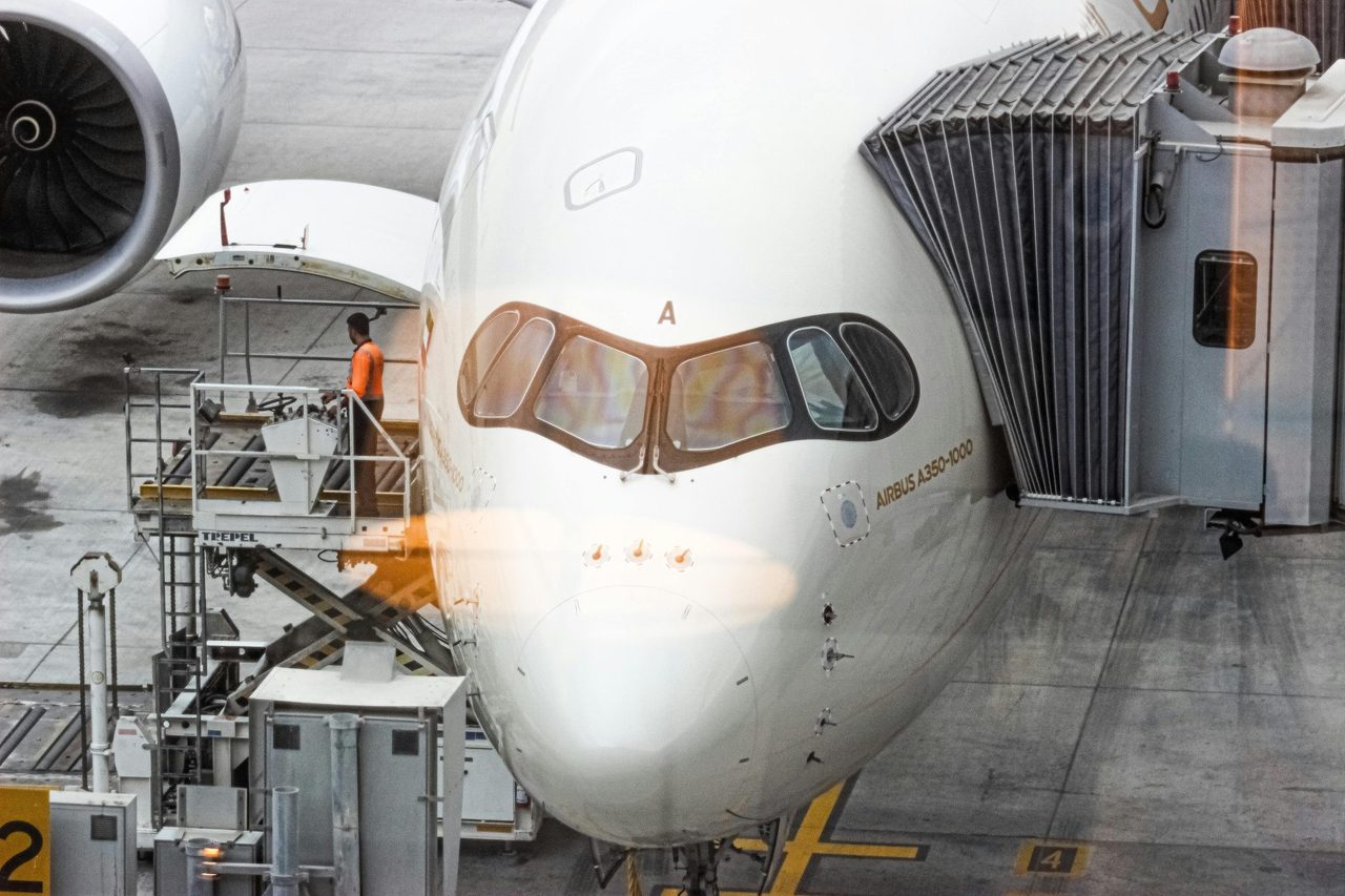 Engineers working an aircraft check inside a maintenance hangar